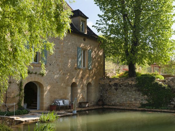 Exterior facade of a french mill and mill pond
